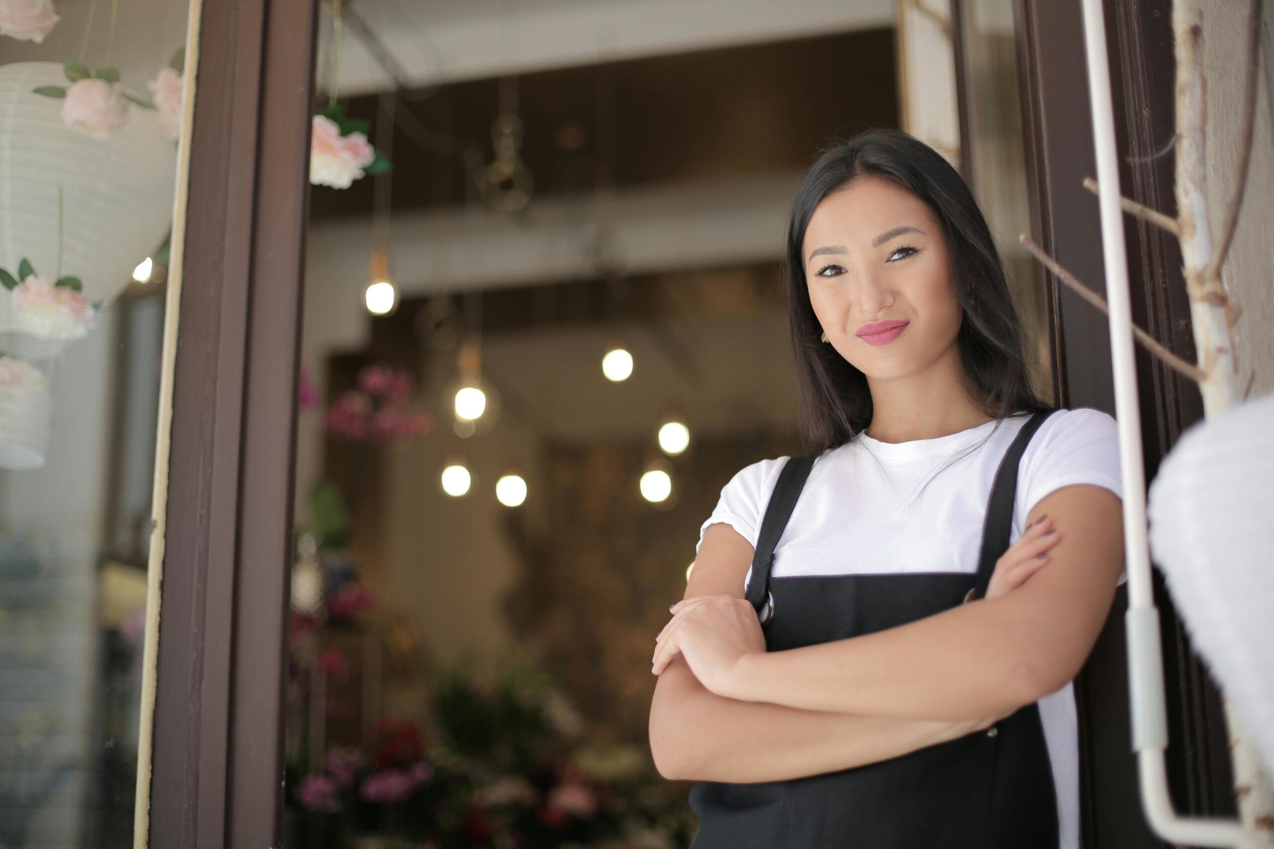 Local business owner greeting customers in front of their shop